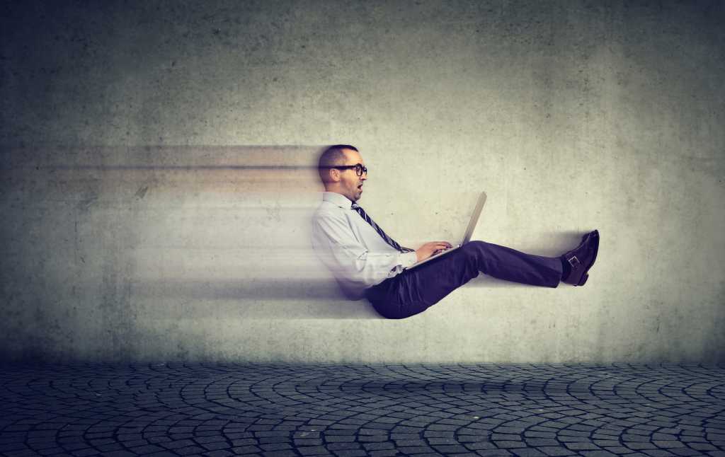 businessman zooming through air with laptop