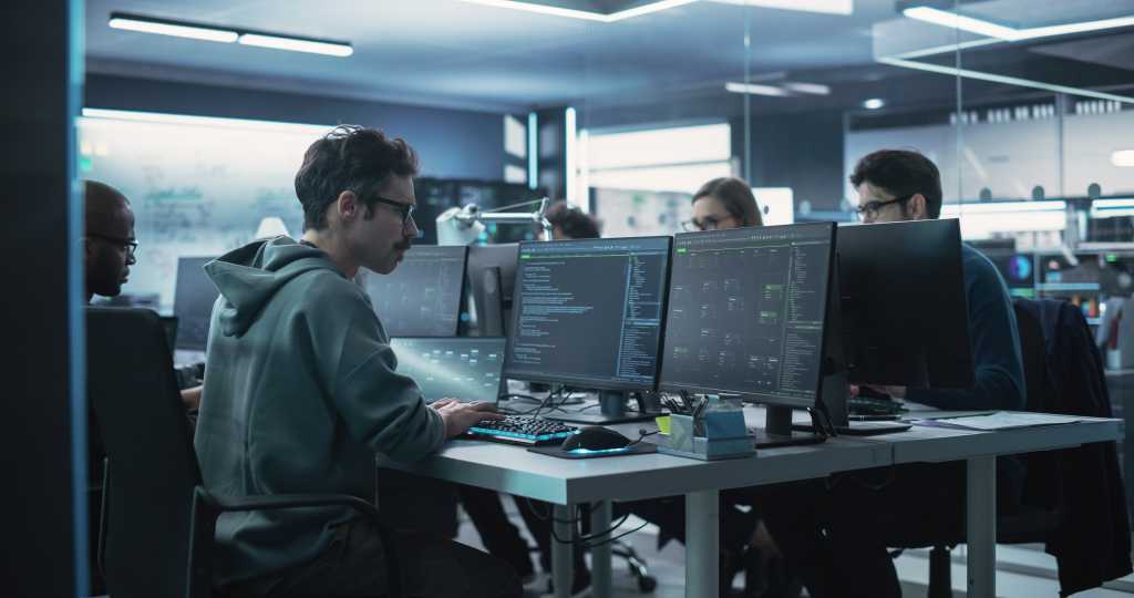 Team of Diverse Multiethnic Software Developers Working on Computers, Programming Advanced Code, Managing Artificial Intelligence Projects Online for Innovative Cyber Security Service